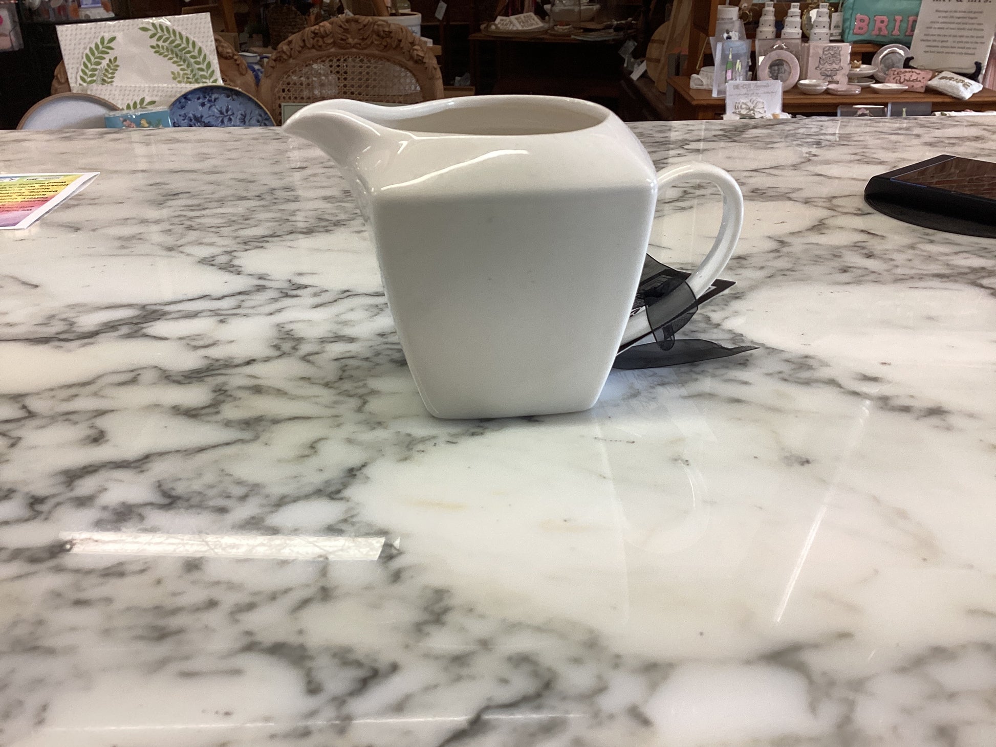 Small porcelain white creamer. Available sizes: small. Simple, smooth finish.