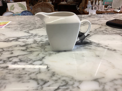 Small porcelain white creamer. Available sizes: small. Simple, smooth finish.