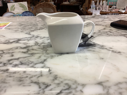 Small porcelain white creamer. Available sizes: small. Simple, smooth finish.