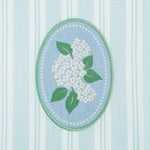 White Hydrangea Embellished Dishtowel with green leaves, light blue background, white dots. Size: 18"x28".