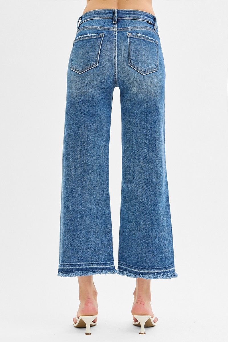 Mid Rise Crop Wide Jeans in medium wash denim with frayed hems. Available in sizes 24–32.