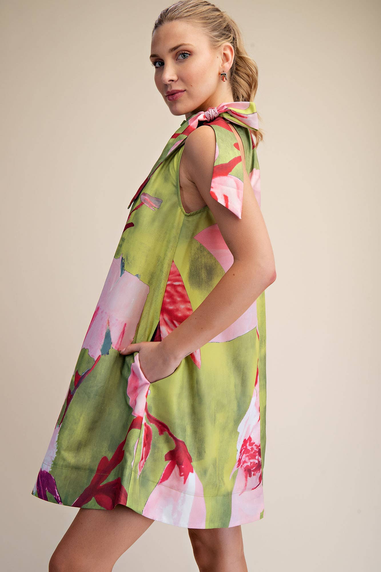 Mini Dress Ruffle Neck Tie Sleeveless Floral Print in Royal, available in sizes XS-XL. Features pockets and ruffle neckline.