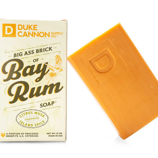 Duke Cannon's Big Ass Brick of Soap - Bay Rum: rectangular orange soap bar with notes of citrus, musk, and cedarwood. Available size: 10 oz.