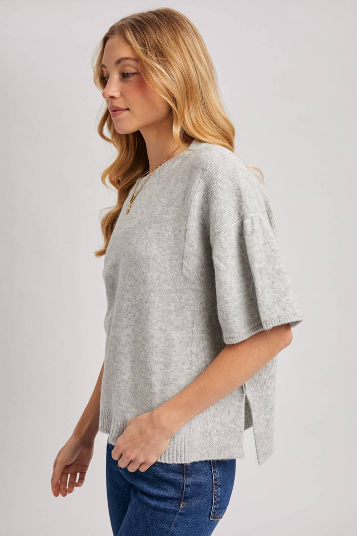 Gathered short sleeve boxy knit sweater top in light grey heathered knit with boxy fit, gathered sleeves, and side slit. Size: M/L.