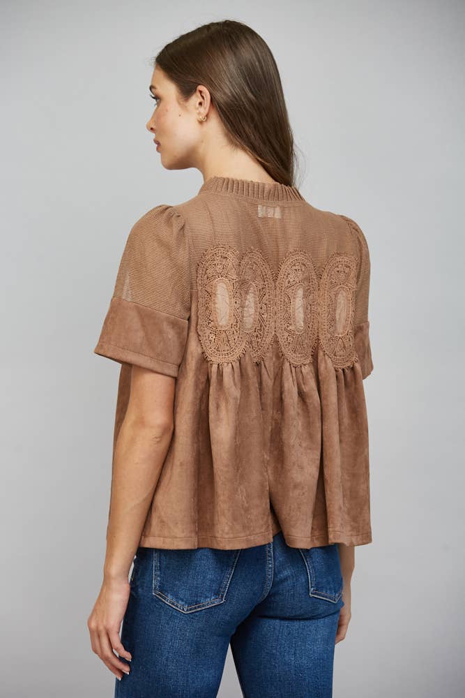 Teal blue faux suede top with short sleeves, mock neck, sheer mesh upper panel, and lace appliqué. Available in all sizes.