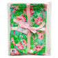 A Pink Floral Blanket+Bib Baby Shower Gift Set with green flip-flops with pink details, strapped together with a pink ribbon, and displayed in clear plastic packaging.