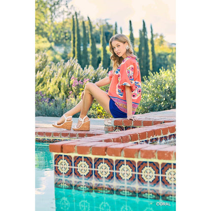 Sunset Floral Embroidery Top, available in sizes XS-XL. Features vibrant floral embroidery on lightweight fabric.