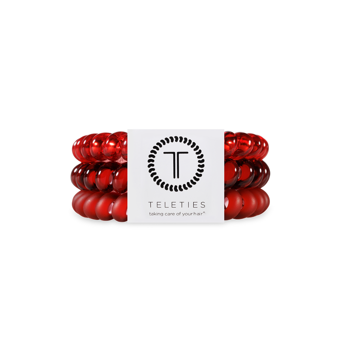 Three red Spiral Hair Coils with a white TELETIES label; available in small, medium, and large. Strong grip, gentle on hair.