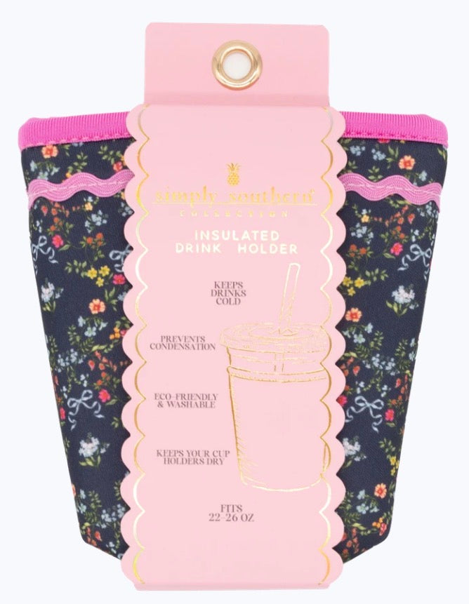 Navy blue flower insulated drink holder with pink accents and label, fits 22–24 oz cups, keeps drinks cold, prevents condensation, eco-friendly, washable.