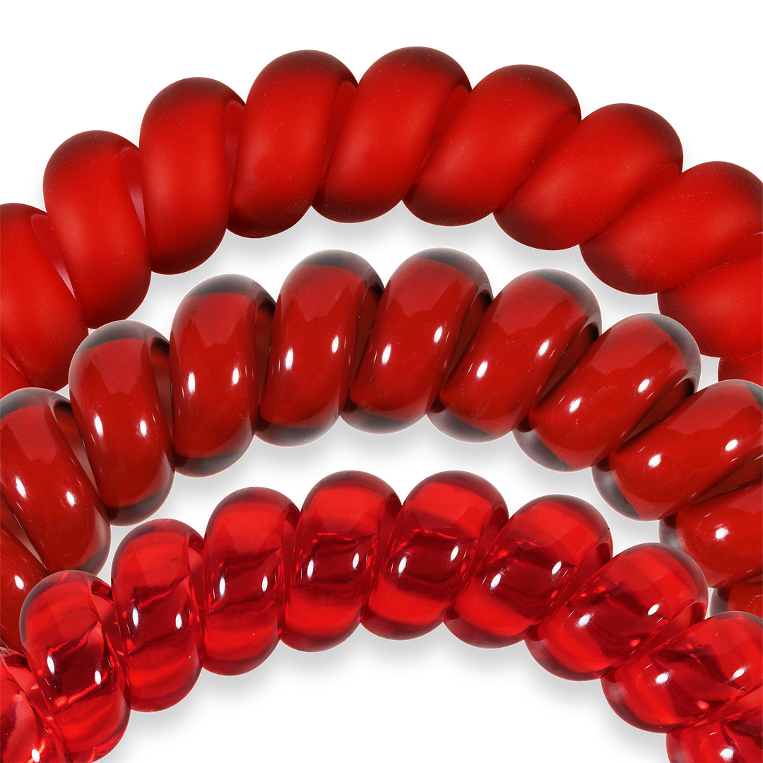 Three red spiral hair coils in matte, glossy, and transparent finishes; strong grip; available in small and large sizes.