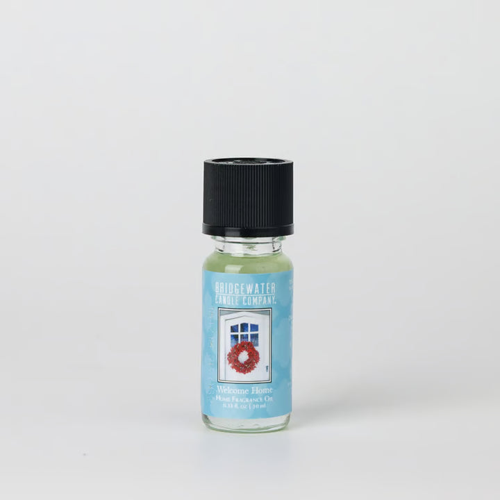 Welcome Home Fragrance Oil, 0.33 fluid ounce glass bottle with black cap and door-and-wreath label.