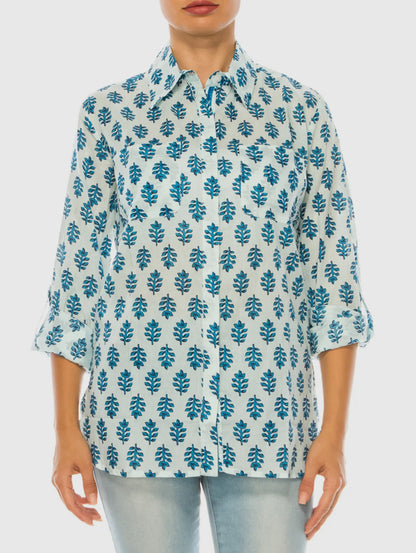 Light blue cotton voile button down shirt with dark blue leaf pattern and rolled-up sleeves. Sizes: XS–XL.