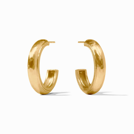 The Cannes Hoop Gold Earrings by Julie Vos are thick, rounded gold hoops with textured inner edges; available in two sizes.