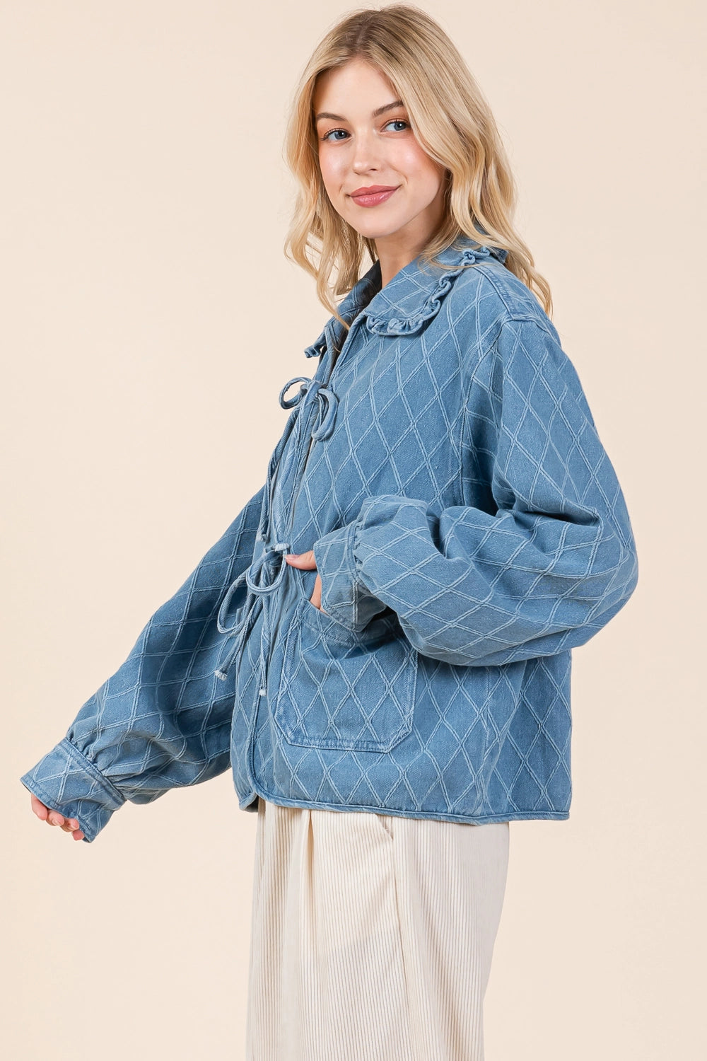 Quilted Denim Jacket: Light blue with ruffle hem collar and tied front details. Sizes available: XS, S, M, L, XL.