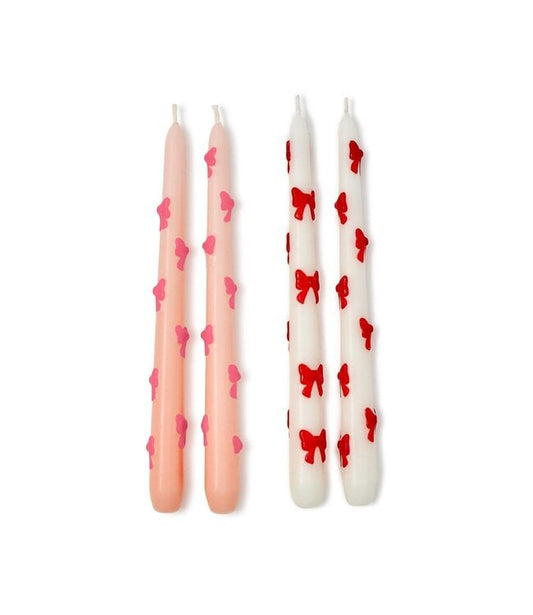 Set of 2 Bow Taper Candles: one light pink with pink bow, one white with red bow. Gift boxed. Sizes available: standard taper.