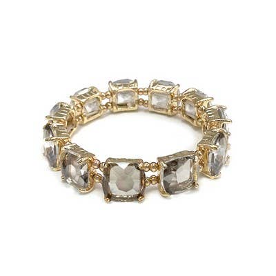 Kaster Topaz Bracelet: square-cut clear gems in gold prongs, flexible loop. Available sizes: S, M, L.