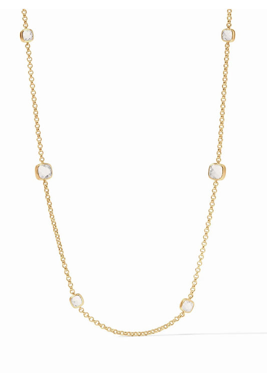 The Aquitaine Station Necklace is a chic accessory featuring varying sizes of glittering clear crystals, all bezel-set and evenly spaced. The necklace is luxuriously made from gold to add sparkle to any attire. Preferably showcased against a white background for aesthetic appeal. This product comes in one standard size.