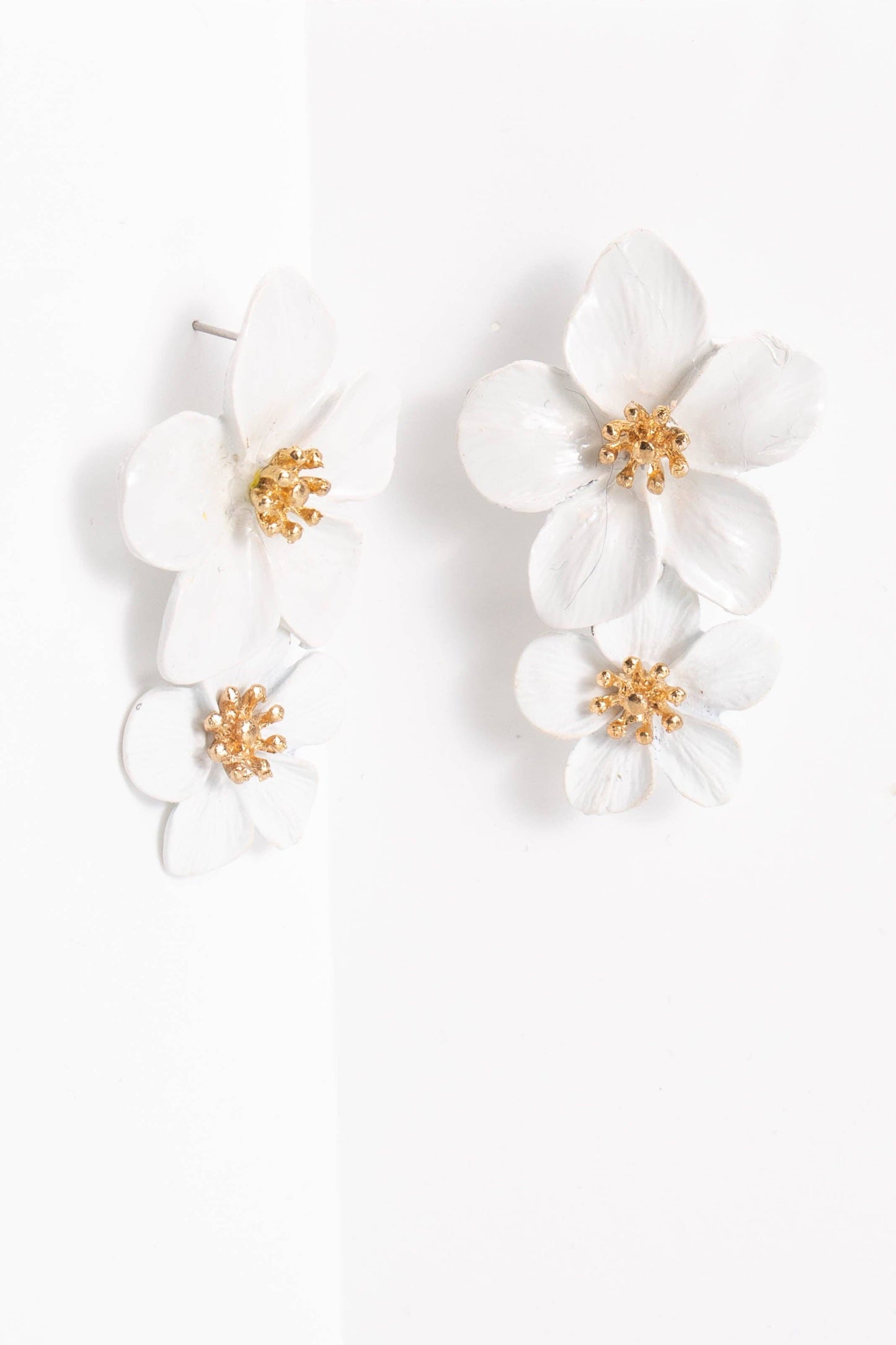 The Belle Floral Drop Earrings: Orchid have three layered white orchid blooms with gold centers; available in one size.