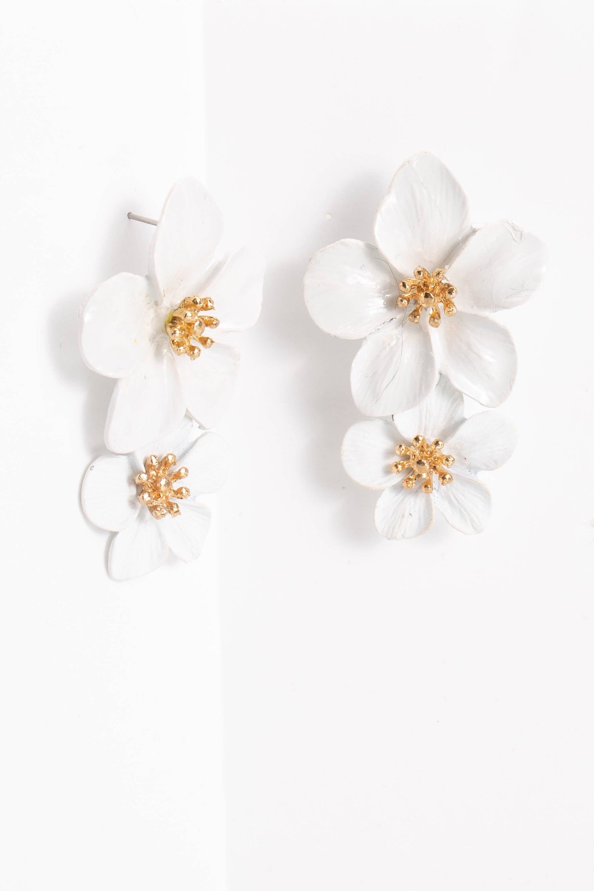 The Belle Floral Drop Earrings: Orchid have three layered white orchid blooms with gold centers; available in one size.