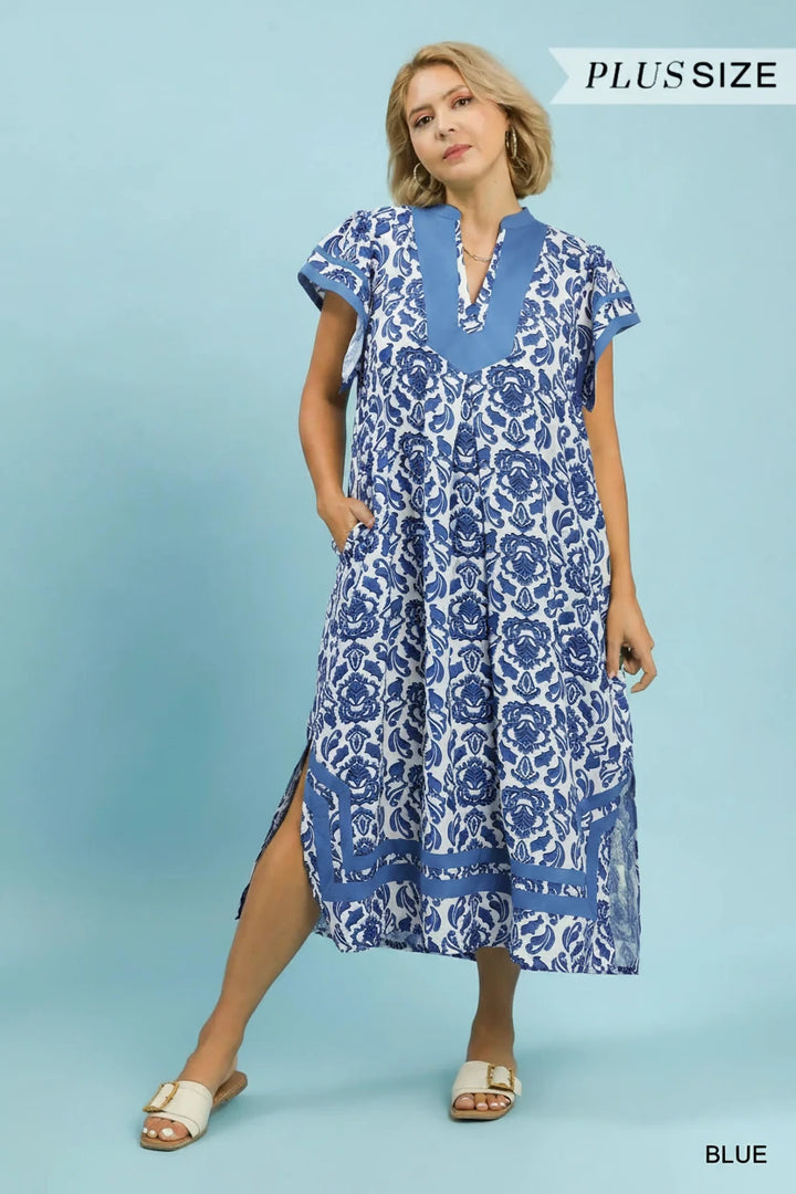 Blue Abstract Two Tone Print Midi Dress; plus-size; short sleeves; blue and white abstract pattern; side slits. Available in sizes 1X–4X.