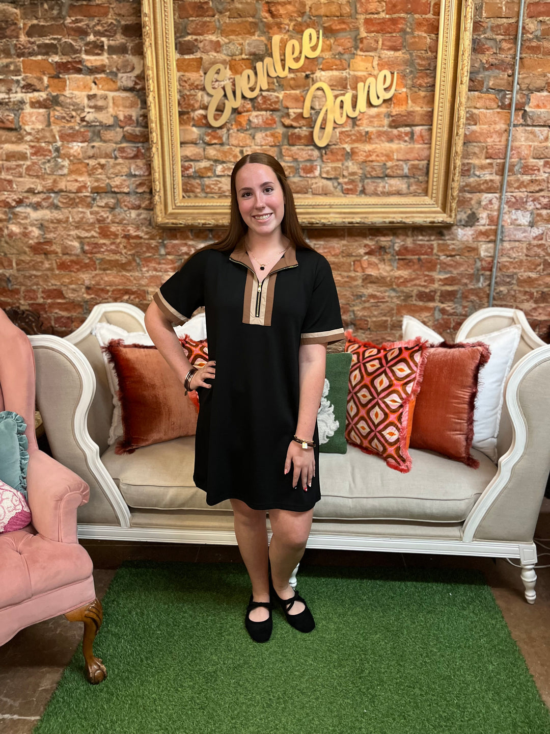 Carly Black and Brown Half Zip Dress, short-sleeved with brown collar, brown cuffs, and gold-toned half-zip. Sizes available.