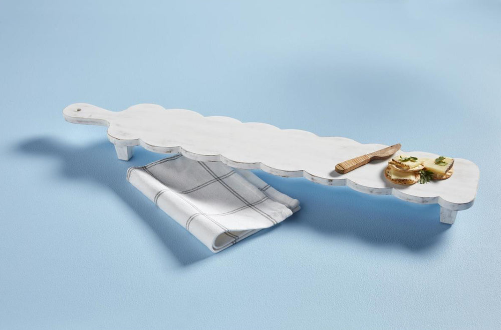 Mango wood cheese board with scalloped edges and short legs. Available in multiple sizes as The Scallop Long Board Set.