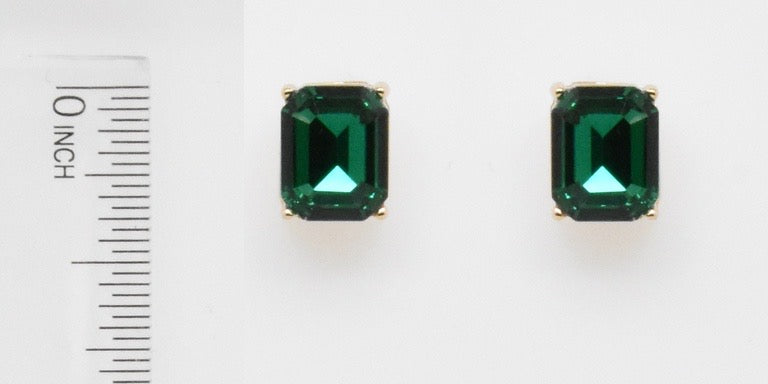 Rectangular emerald studs set in gold; each earring is just under 0.5 inches long. Size: just under 0.5 inches.