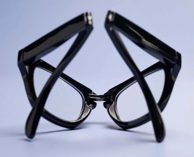 Black folding Peepers Twofold reading glasses, shown folded; available in multiple sizes.