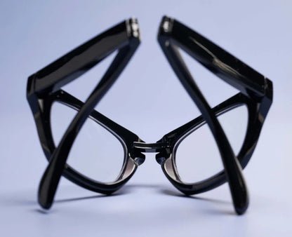 Black folding Peepers Twofold reading glasses, shown folded; available in multiple sizes.