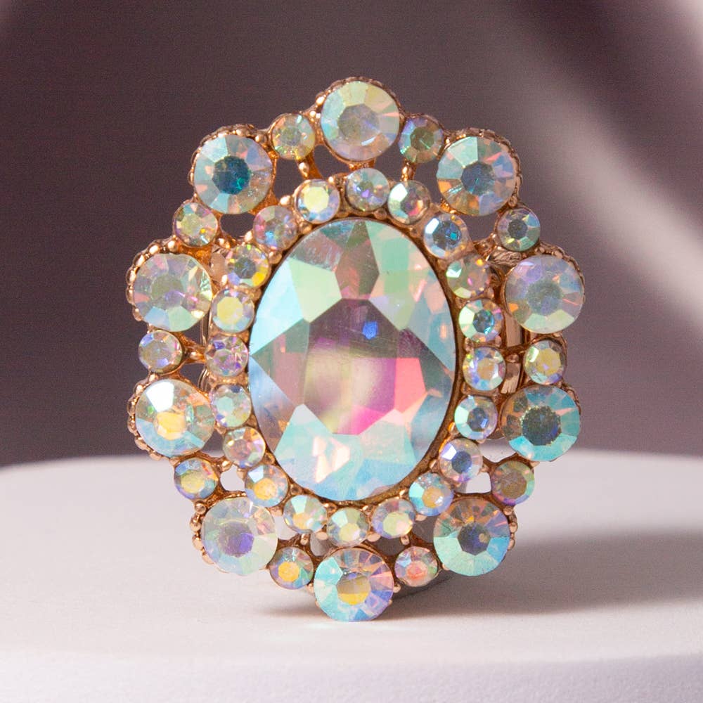 Oval Crystal Sunburst Double Halo Stretch Ring with iridescent oval center, double halo of multicolored stones in gold. Sizes: S/M, M/L.