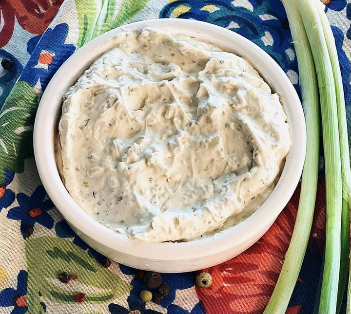 JR’S Ranch Dip &amp; Cheeseball Mix, creamy and flecked with herbs, in a white bowl. Available in 8oz and 16oz sizes.