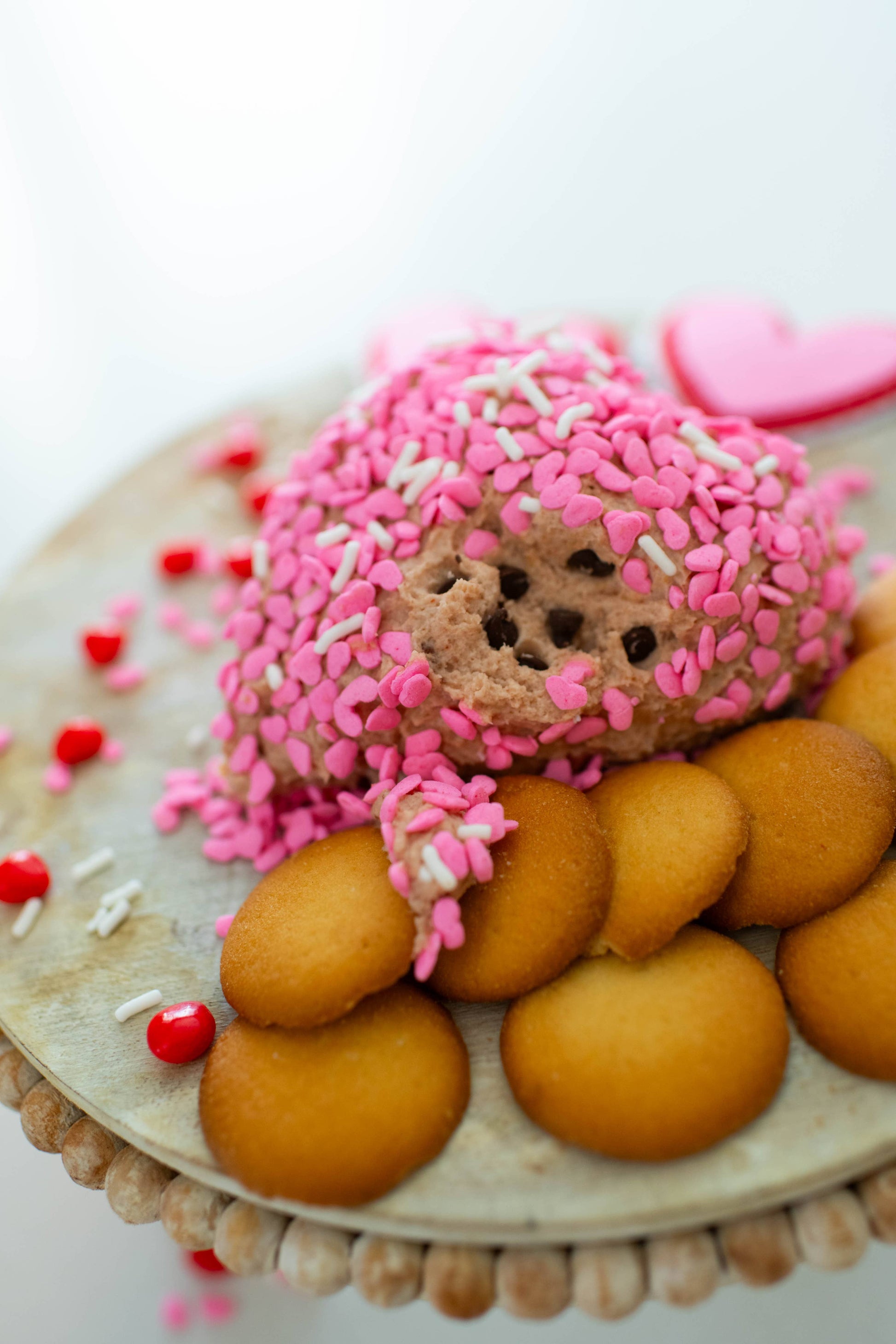 Chocolate Chip Cookiedough Cheesecake Dip with pink sprinkles. Available in small, medium, and large sizes.