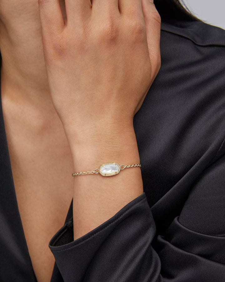 Elaina Adjustable Bracelet in Mother Of Pearl by Kendra Scott: oval white stone, gold adjustable chain. Available in one size.
