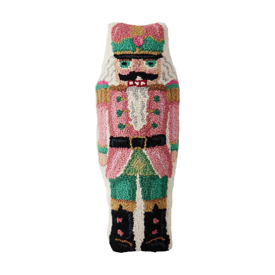 Shaped Pink Nutcracker Hook Pillow made of wool, featuring a pink, green, and white uniform, black boots, and a mustache in hooked fabric. Available sizes: 13″x22″.