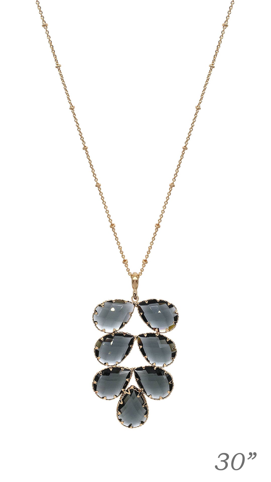 Gold chain necklace with six clustered dark gray teardrop gems, 30" length. Designed by Meghan Browne Style.