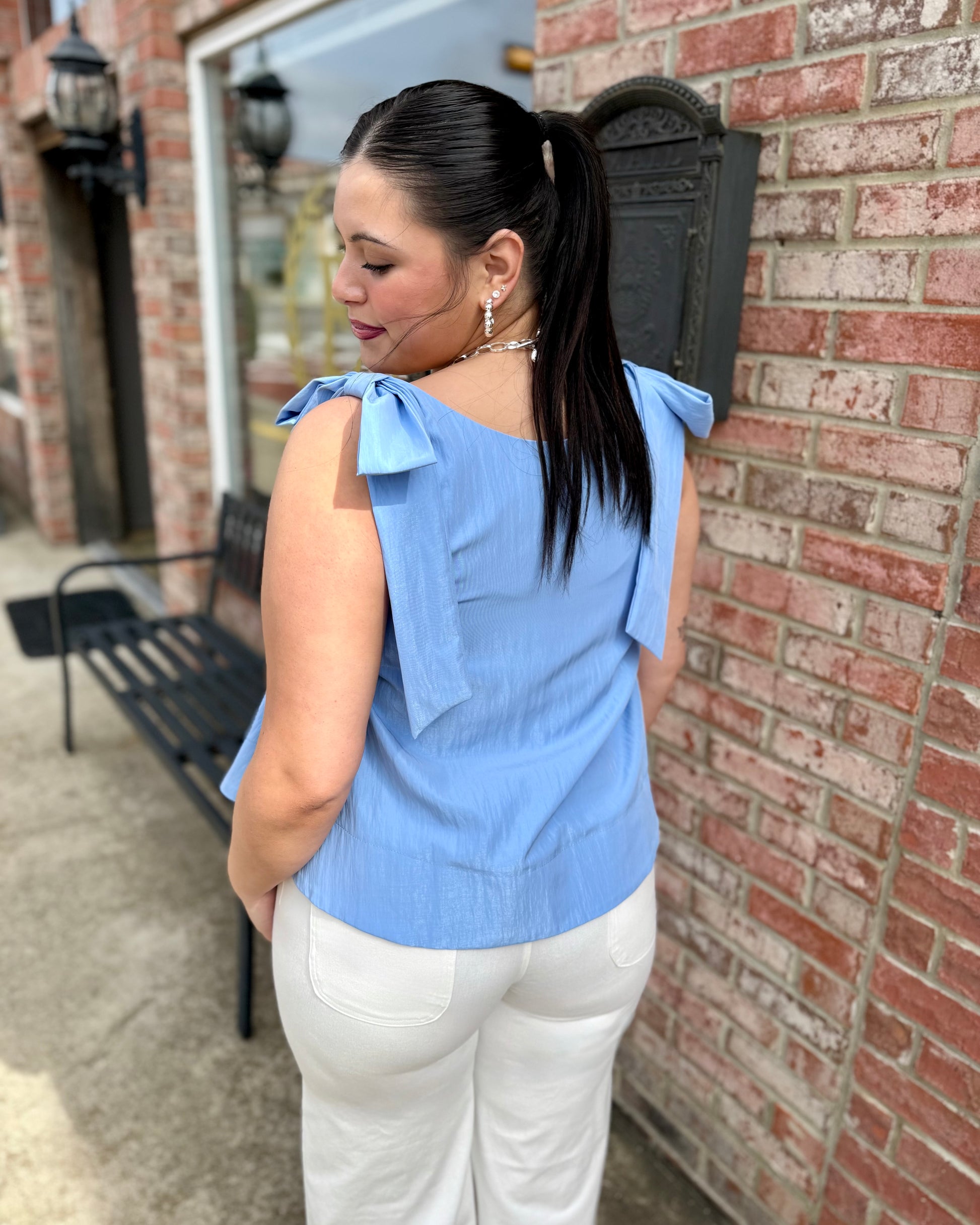 Sky Scoop Neck Bow Shoulder Top in light blue, features bow details at shoulders. Available in sizes XS–XL.