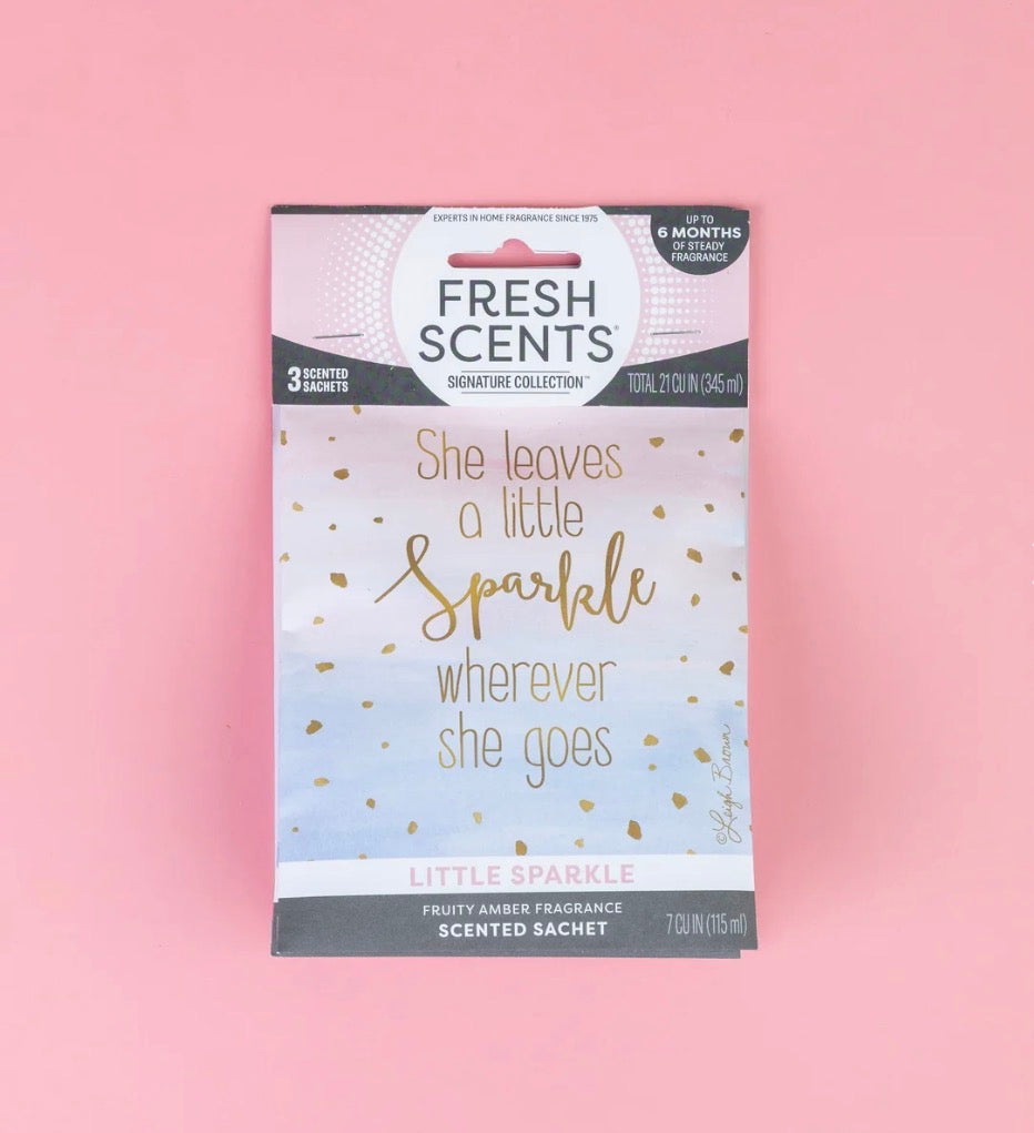 The Little Sparkle Scented Sachet features the phrases “She leaves a little sparkle wherever she goes” and “Little Sparkle, fruity amber fragrance.” This flameless sachet provides a long-lasting home fragrance. Sizes available: [sizes not specified].