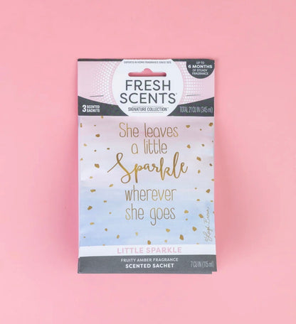 The Little Sparkle Scented Sachet features the phrases “She leaves a little sparkle wherever she goes” and “Little Sparkle, fruity amber fragrance.” This flameless sachet provides a long-lasting home fragrance. Sizes available: [sizes not specified].