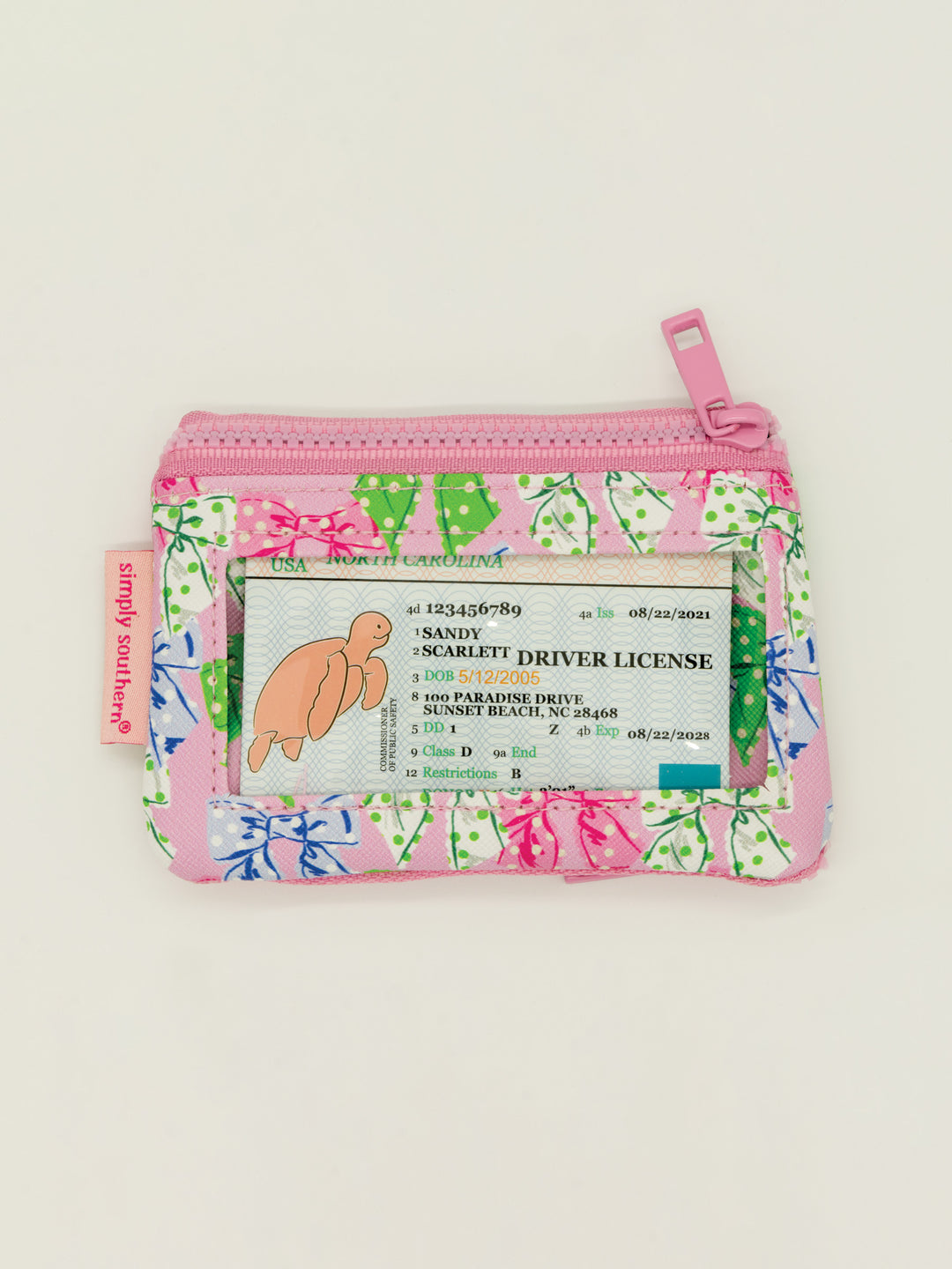 Small zippered key chain wallet with clear window, pink/blue/green leaf print on white. Available in one compact size.