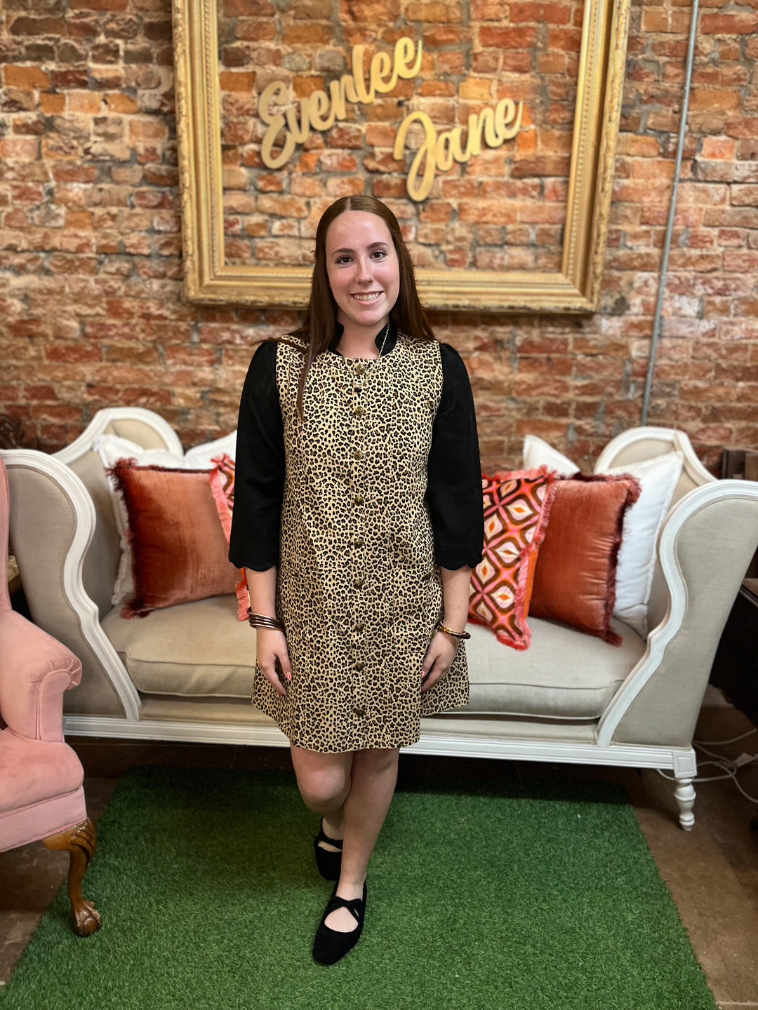 Leopard denim dress with black three-quarter sleeves and front button closure, available in multiple sizes.