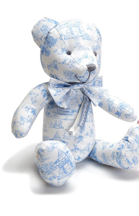 Stuffed teddy bear with white and light blue scenic print, matching bow. Available sizes: small, medium, large.