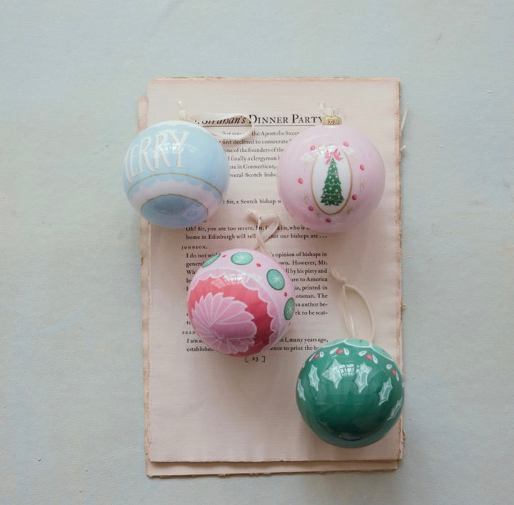 Four decoupage ball ornaments with colorful designs, available in multiple sizes.