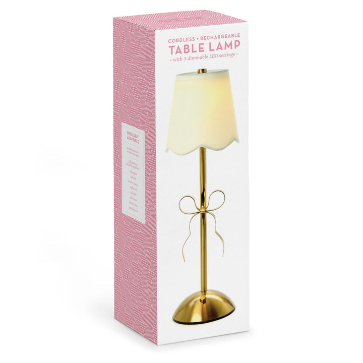LED Cordless Gold Bow Table Lamp with gold base, bow detail, white shade; available sizes listed on packaging.