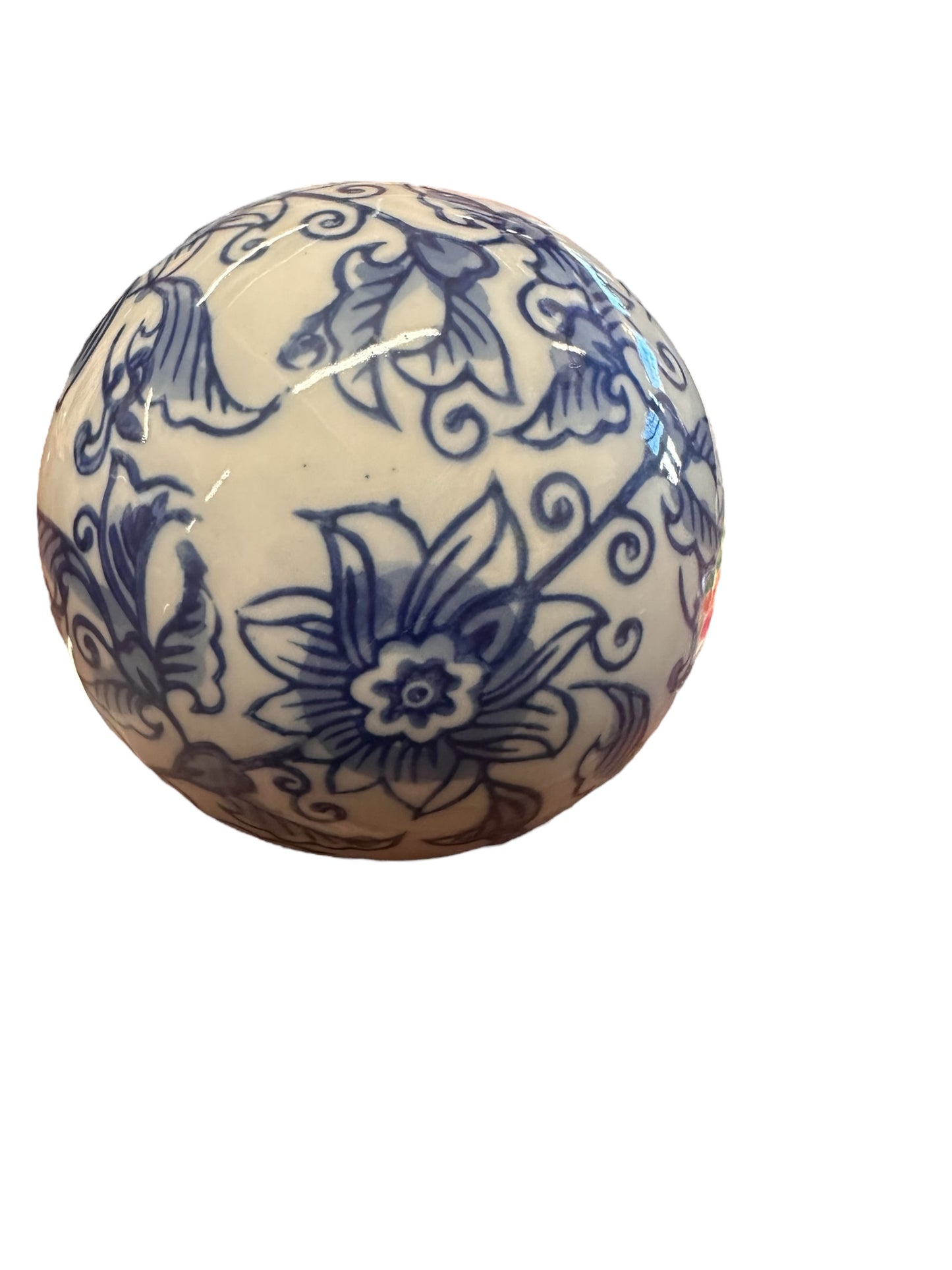 Ceramic Blue & White Decorative Ball features intricate floral and foliage patterns on a round porcelain surface, set against a plain white background. Available sizes: Small, Medium, Large.