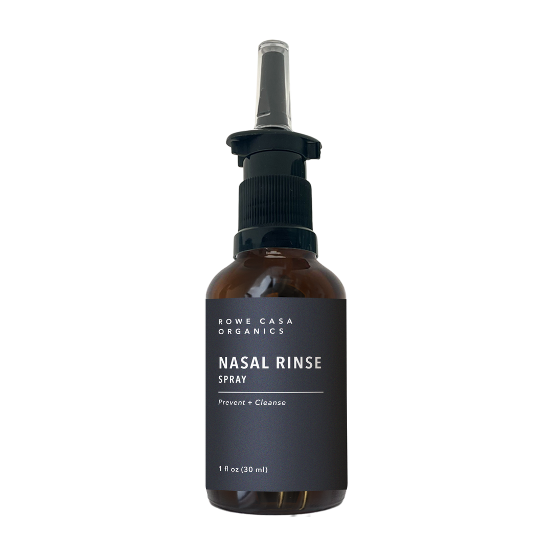 Brown 1 oz (30 ml) bottle of Rowe Casa Organics Nasal Rinse Spray with a black label reading “Prevent + Cleanse” and a spray nozzle.