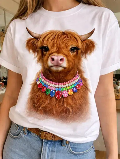 White "Jeweled Collar Highland Calf" crewneck with a vibrant Highland calf illustration, jeweled collar, long lashes, hand-embellished details, and jumbo bling. Available in sizes S-XXL.
