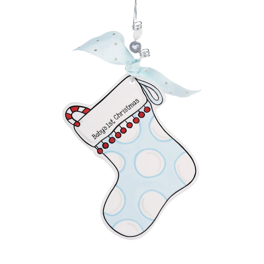 Hand-painted Blue Stocking Flat Ornament featuring a light blue pattern with white circles, a red and white candy cane accent, and “Baby’s 1st Christmas” text.