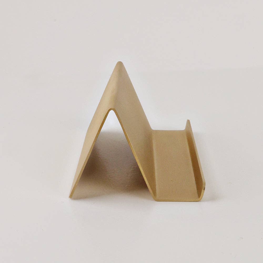 Minimalist triangular brass card holder in satin finish; available in multiple sizes.
