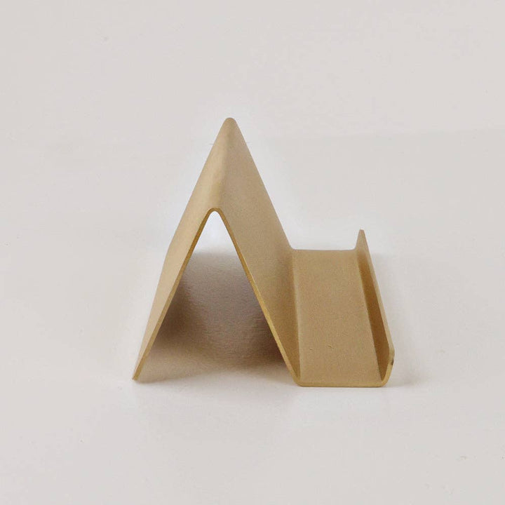 Minimalist triangular brass card holder in satin finish; available in multiple sizes.