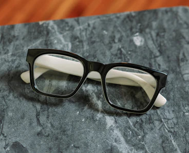 The Peepers - Boone eyeglasses with black-rimmed acetate frame and white temples. Available sizes: Small, Medium, Large.